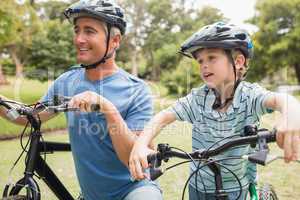 Happy father on a bike with his son