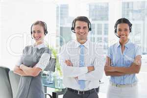 Business people with headsets smiling at camera