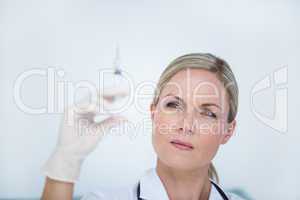 Doctor preparing syringe