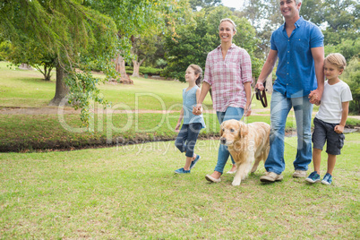 Happy family in the park with their dog