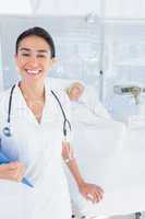 Smiling doctor looking at camera in patients room