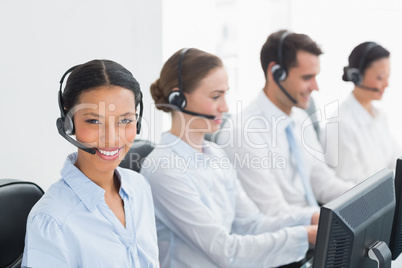 Business people with headsets using computers