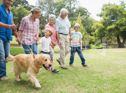 Happy family in the park with their dog