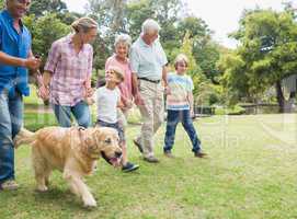 Happy family in the park with their dog