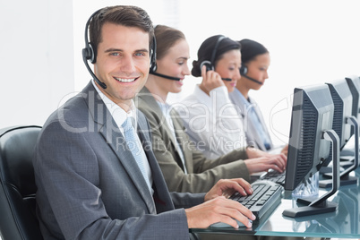 Business people with headsets using computers