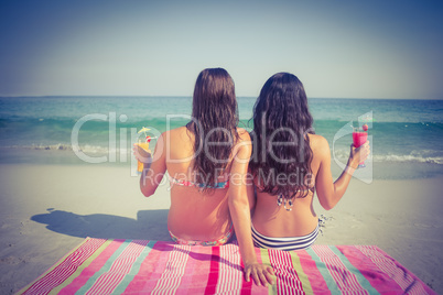 Two friends in swimsuits at the beach