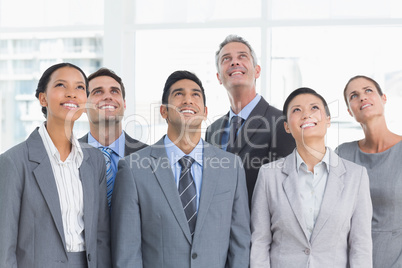 Business people looking up in office