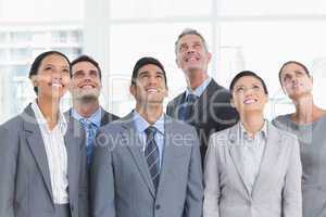 Business people looking up in office