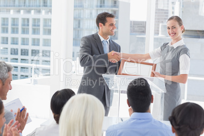 Business people receiving award