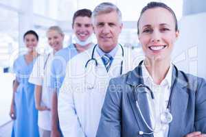 Smiling team of doctors standing in line