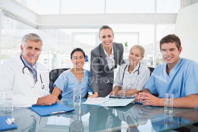 Team of doctors and businesswoman having a meeting