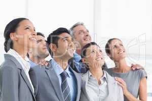 Business people looking up in office