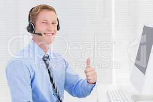 Handsome agent with headset smiling at camera