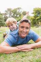 Happy father and his son smiling at camera