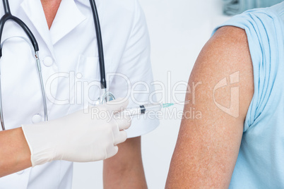 Doctor doing an injection to her patient