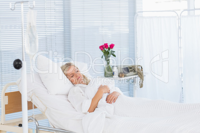 Happy patient lying on her bed