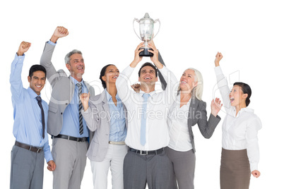 Business people holding cup and cheering