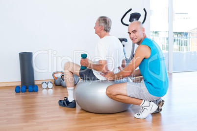 old man having back massage on exercise ball