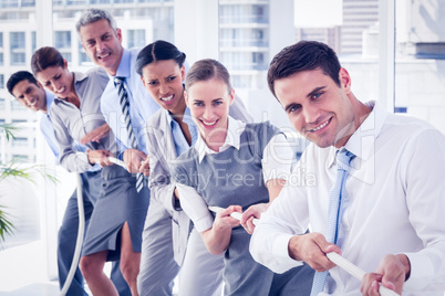 Business people pulling rope