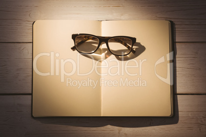 Empty notepad with reading glasses