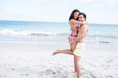 Happy couple hugging and looking at camera Happy couple hugging and looking at camera