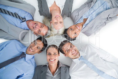 Young business people lying in circle