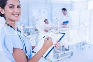 Smiling doctor checking patients file