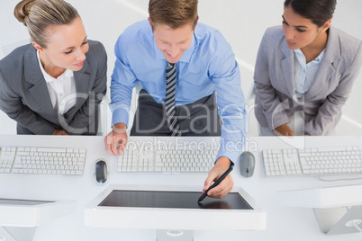 Businessman showing his screen to the team