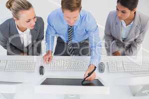 Businessman showing his screen to the team