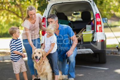 Happy family with their dog in the park