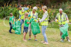 Happy family collecting rubbish