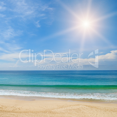 ocean, sandy beach and blue sky