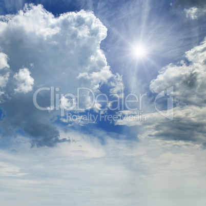 sun on blue sky with white clouds