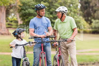 Happy multi generation family on their bike at the park