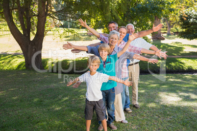 Happy family with arms outstretched in the park