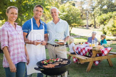 Happy man doing barbecue for his family