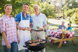 Happy man doing barbecue for his family