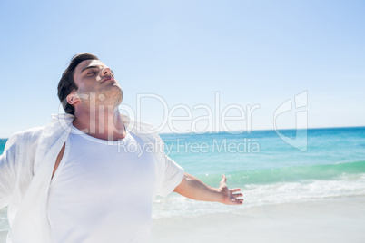 Man stretching his arms in front of the sea