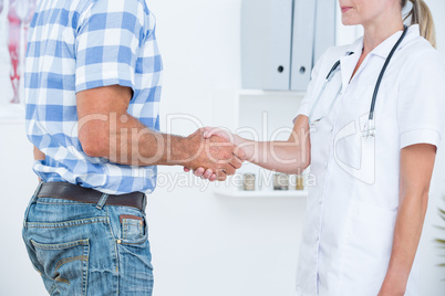 Patient shaking hands with doctor