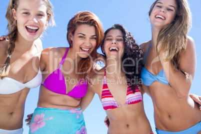 Beautiful women standing together arm around