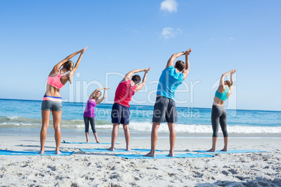 Friends stretching together with their teacher