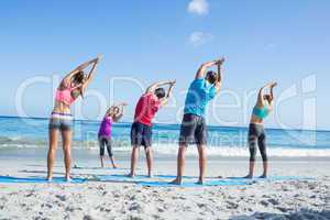 Friends stretching together with their teacher