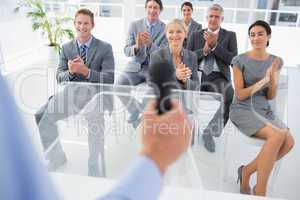 Business team applauding during conference