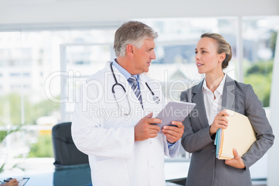 Confident doctor and pretty businesswoman discussing