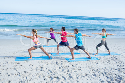 Friends doing yoga together with their teacher