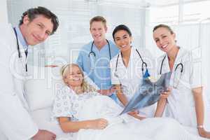 Smiling doctors showing xray to patient