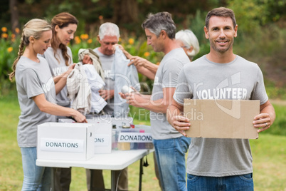 Happy volunteer family holding donation boxes