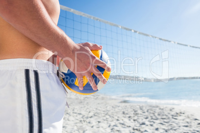 Handsome man holding volleyball