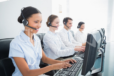 Business people with headsets using computers