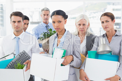 Unhappy fired business people holding box